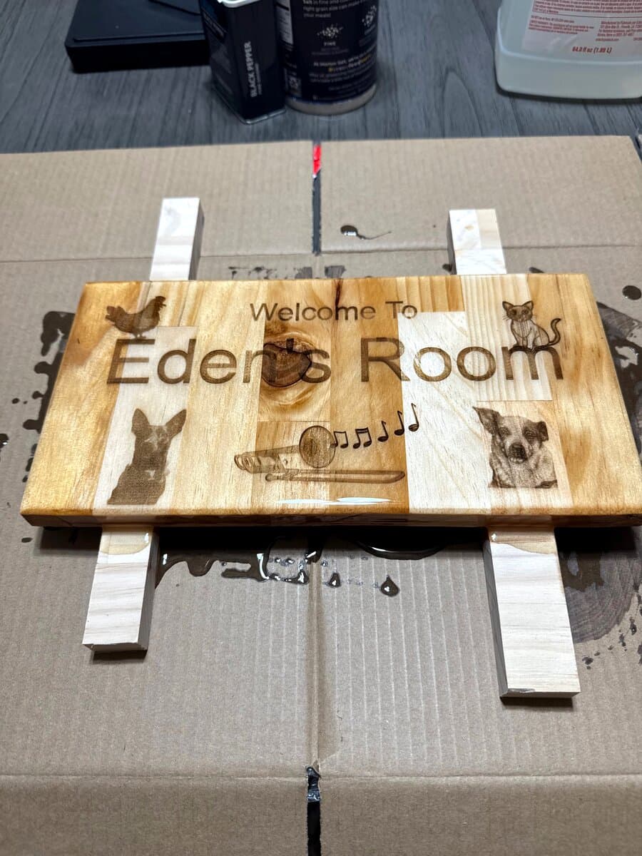 Eden's Room sign elevated during epoxy coating process